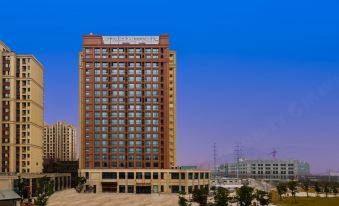 "a tall building with a sign that says "" super hotel "" is surrounded by other buildings" at Atour Hotel