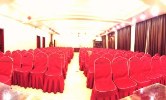 There are rows of red chairs in a large conference room available for hosting events or special occasions at Famen Temple Hotel