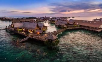 city, where one can enjoy the picturesque view of houses and restaurants situated on the waterfront during the enchanting hours of dusk or sunset at Sipadan Kapalai Dive Resort