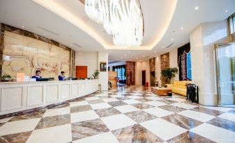 a luxurious hotel lobby with a marble floor and a check - in desk , featuring a large chandelier hanging from the ceiling at Mediterranean Hotel