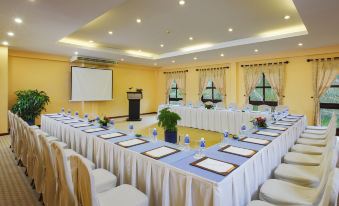 a large conference room set up for a meeting , with chairs arranged in a semicircle around a table at Pandanus Resort
