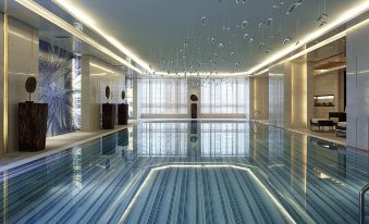 The hotel offers a spacious room with an indoor pool and floor-to-ceiling windows that provide a scenic view of the water at Courtyard by Marriott Shanghai Central