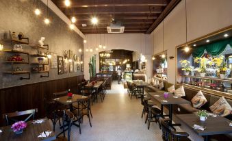 a large dining room with multiple tables and chairs arranged for a group of people to enjoy a meal together at Kimberley Hotel Georgetown