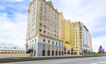 a tall building with apartments in the middle and on top, located across from it at Harbourview Hotel