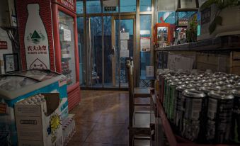 A room equipped with filled shelves, doors, and an empty refrigerator is available for guests to use at Paoju Factory Youth Hostel (Beijing Summer Palace Subway Station Branch)