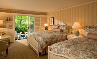 a hotel room with two beds , one on the left and one on the right side of the room at Wequassett Resort and Golf Club