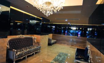 A large room with chandeliers and a seating area in the middle, alongside ornate decorations at Ramada Hong Kong Grand