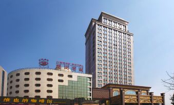 "A large building with the word ""hotel"" displayed on its side, offering an exterior view" at Jinghu Hotel