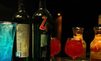 a bottle of zetes mint wine is placed next to two glasses filled with red liquid at Imperial Hotel