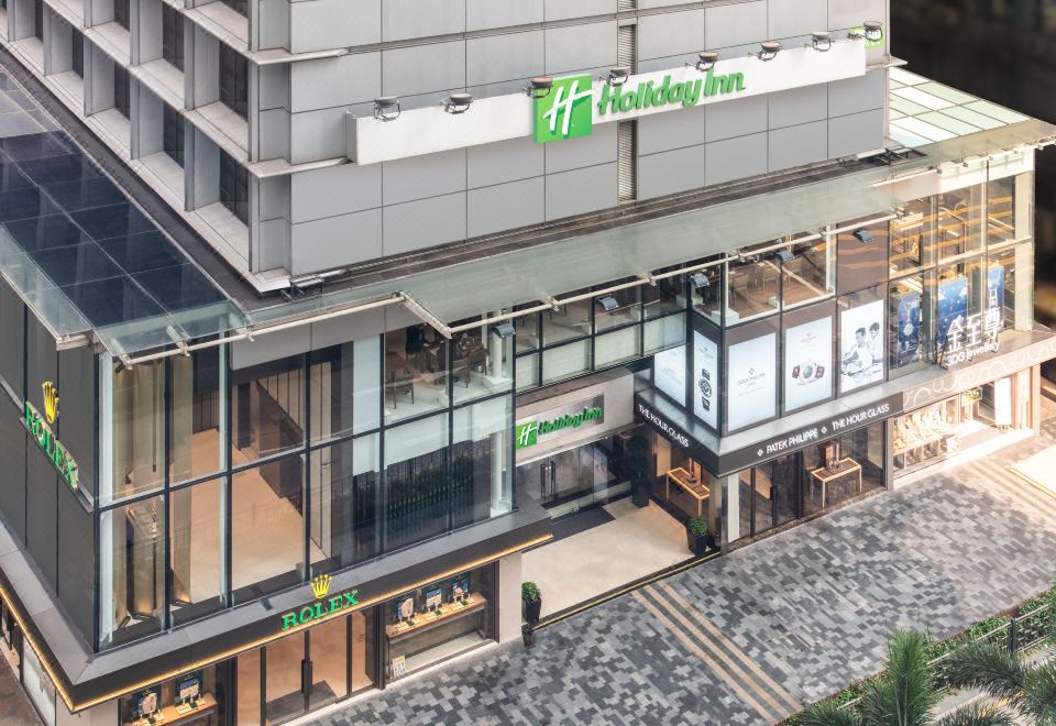 The front entrance of a hotel in an urban setting features large windows and a glass facade at Holiday Inn Golden Mile