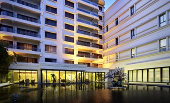 A two-story building is situated beside another, illustrating the water level at Metropolo Dahua Hotel Shanghai