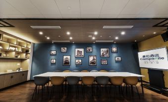 a conference room with tables and chairs, and adjacent to it is an office space at Campanile Shanghai Huaihai Hotel