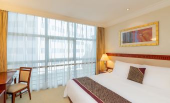 elegant desk and a cozy armchair for relaxation at Metropark Hotel Shenzhen