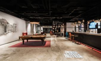 has tables and chairs in the center, adjacent to an open kitchen at Pentahotel Hong Kong, Tuen Mun