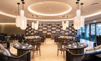 a large dining room with multiple tables and chairs arranged for a group of people to enjoy a meal together at Alma Resort Cam Ranh