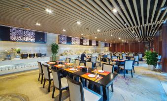 a large dining room with multiple tables and chairs arranged for a group of people to enjoy a meal together at Fuzhou Hotel