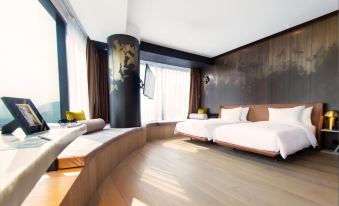 A bedroom with two beds and a large window on the wall, accompanied by side tables at YOHO Hollywood Roosevelt Hotel