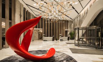 A spacious lobby or reception area featuring an artistic design and a modern chandelier at International Youth Convention Hotel (Nanjing International Youth Cultural Centre)