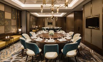 The modern-style meeting room features large round tables and chairs for dining at International Youth Convention Hotel (Nanjing International Youth Cultural Centre)