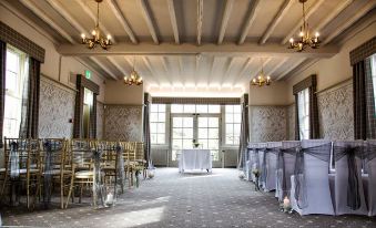a large room with chairs arranged in rows and a chandelier hanging from the ceiling at The Stair Arms Hotel