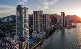 a city skyline with tall buildings and a swimming pool , set against a backdrop of mountains at Hompton Hotel by The Beach