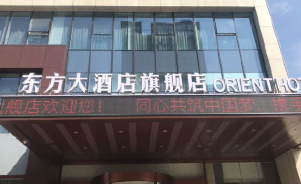 "a building with a large sign on the front that reads "" jinjiang inn "" in chinese" at Orient Hotel