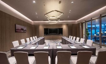 A spacious conference room is arranged with long tables and chairs for hosting events or private meetings at Aerotel Beijing
