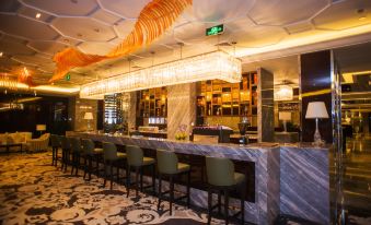 The restaurant's bar is modern with a large glass entrance at KinDream Hotel