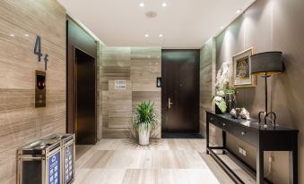 This modern home features an entrance with an elevator and wood-paneled walls at Yunrui Hotel, Zhongshan Park, Shanghai
