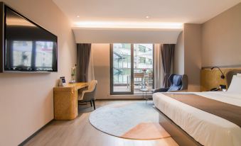 A bedroom with large windows, a TV, and a bed in the center is fully equipped at SKYBIRD Hotel (Shanghai Hongqiao Airport)