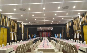 a long banquet hall with rows of tables and chairs set up for a formal event at Play Phala Beach Rayong