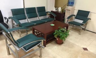 There is a room with chairs and tables arranged in the middle, with an armchair placed on top at 7 Days Inn (Beijing Temple of Heaven Dongmen Metro Station)