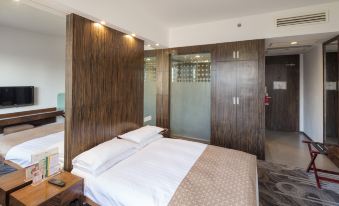 A modern bedroom with a large bed and a walk-in closet is located on the far wall at City Hotel