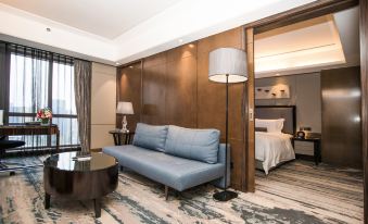 a small room with a desk and chair, and a bathroom attached to it at Pullman Shanghai Jing An