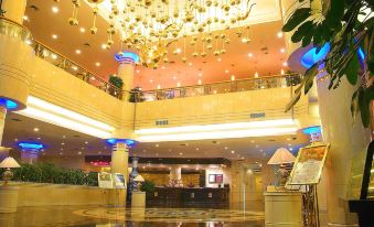 a grand hotel lobby with a large chandelier hanging from the ceiling and a reception desk in the foreground at Phoenix Hotel