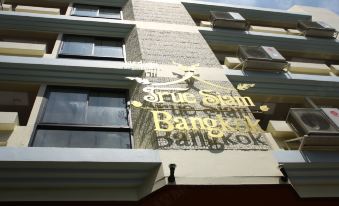 There is a sign on the side wall of an apartment complex that also includes another building at True Siam Phayathai Hotel