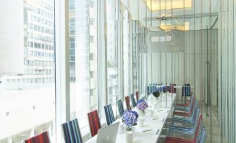 The conference room features large windows and a long table that can accommodate up to six people at iclub Fortress Hill Hotel