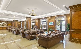 a spacious living room with wooden furniture , including couches and chairs , arranged around a coffee table at Westlake Hotel & Resort Vinh Phuc