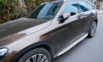 A car with its hood open is parked next to another vehicle in front at Poshpacker Flipflop Youth Hostel (Taikoo Li Chunxi Road Metro Station)