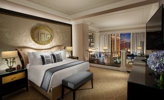 In the middle room, there is a large bed with chairs and tables on both sides, creating an elegant atmosphere at The Venetian Macao