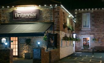 "a restaurant with a sign that says "" titania 's "" is shown at night , with the restaurant 's name displayed on the sign" at The Britannia Inn & Waves Restaurant