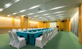 a large conference room with a long table and numerous chairs arranged for a meeting at Good Hotel (Beijing East Road Gaoxin Avenue Subway Station)