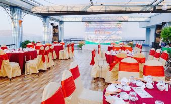 a large banquet hall with multiple tables and chairs set up for a formal event , possibly a wedding reception at Seagull Hotel