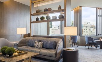 adjacent dining area with a table and chairs at Hyatt Centric Victoria Harbour Hong Kong