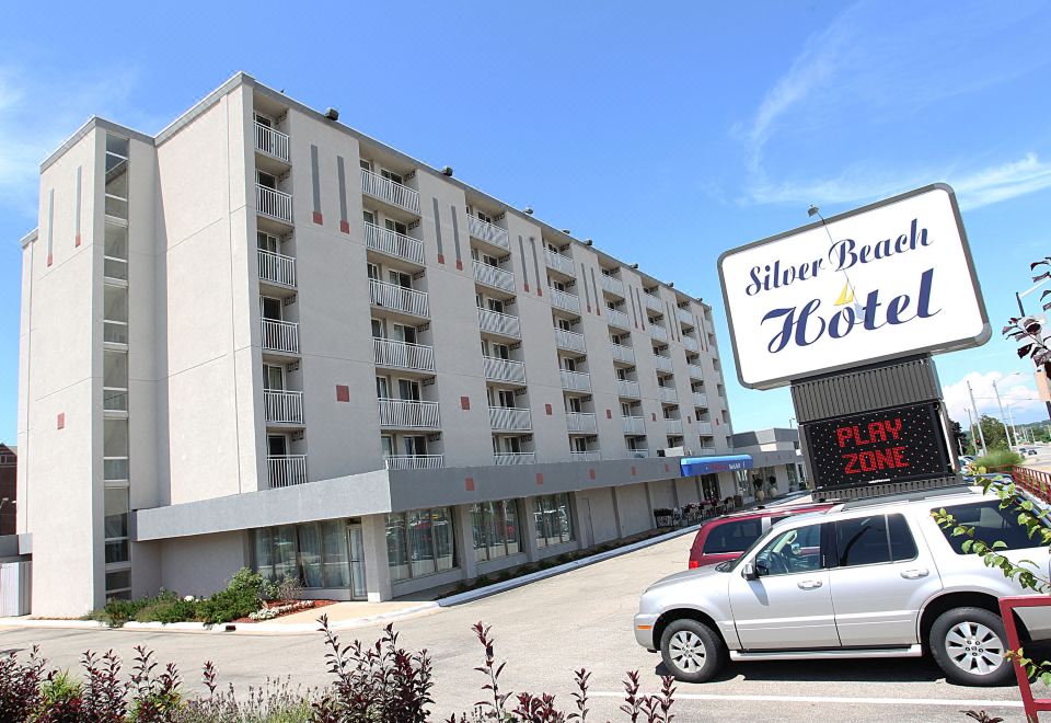 "a large white building with many windows and a sign that reads "" silver harbour hotel "" in front" at Silver Beach Hotel
