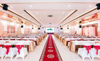 a large banquet hall with multiple tables and chairs set up for a formal event , possibly a wedding or conference at Sepon Boutique Resort