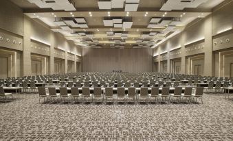 a large conference room with rows of chairs arranged in a semicircle , providing seating for a large group of people at Alila Solo