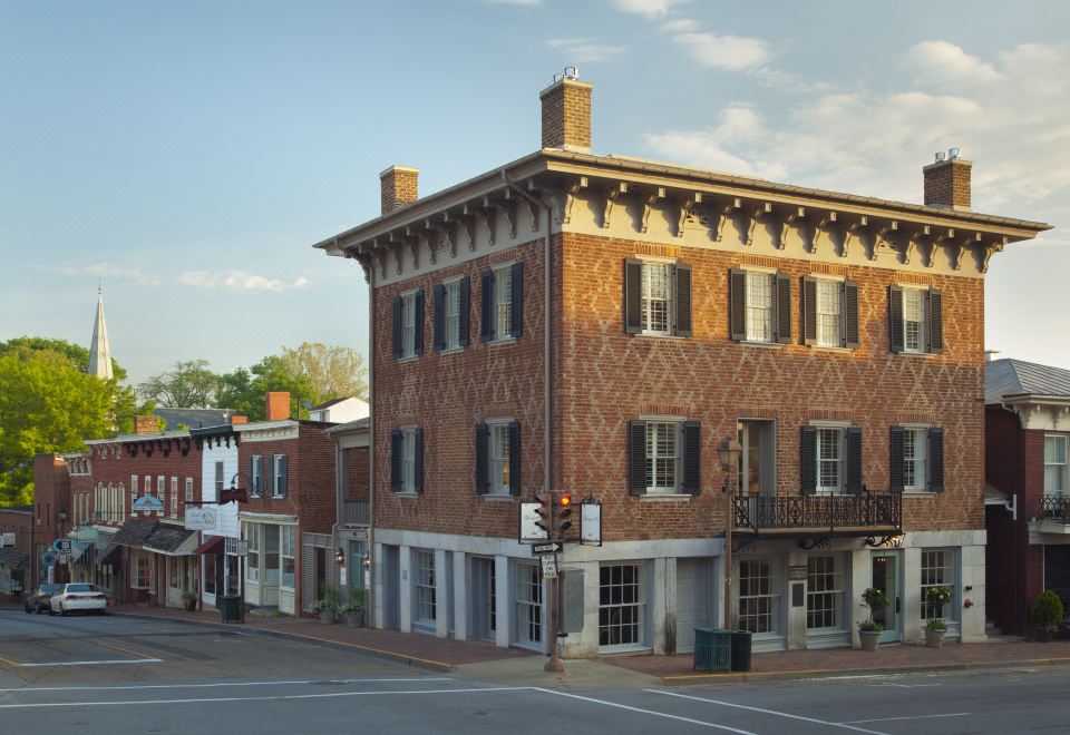 a brick building on a street corner , with a clock on the side of the building at The Georges
