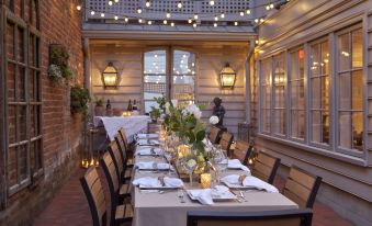 a long dining table set up for a formal dinner , with multiple chairs arranged around it at The Georges