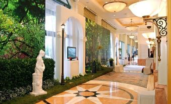an elegant lobby adorned with plants and flowers on the floor, creating a luxurious atmosphere in a high-end establishment at Hanoi Daewoo Hotel